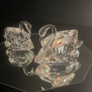 A pair of 2 different sizes Swarovski Iconic Crystal Swan Figurine